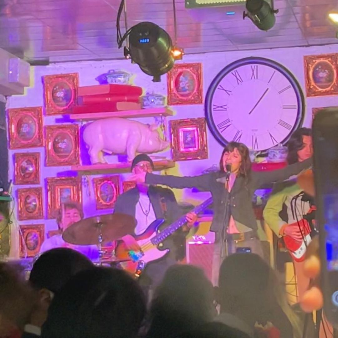 NEWS.Angelica Bove presenta Tana Angelica Bove sul palco con le braccia aperte durante il concerto dal vivo in cui presenta il suo primo album Tana, accompagnata dalla band.